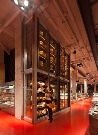 A towering glass cheese cabinet provides expert retail theatre