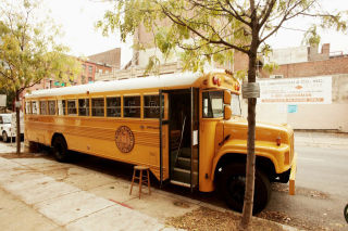 This glorious yellow bus is the Warby Parker Travelling Roadshow