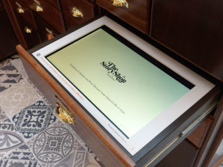 Rather than products, the pull-out drawers feature interactive screens that tell the stories of children in need