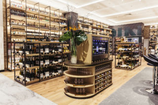 Backlit shelving in the Wine Room creates a warm, welcoming effect while drawing attention to the products on display.