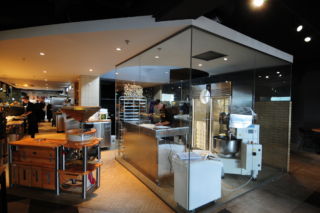 A separate glass-walled dough making room creates visual interest and highlights product freshness.  