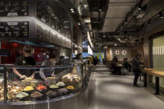 The new design integrates the McCafe setting into the main food preparation area, emphasising freshness and personalisation. 