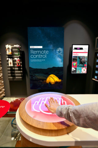 Gesture-controlled video kiosks allow customers to engage with the stories and products on offer. 