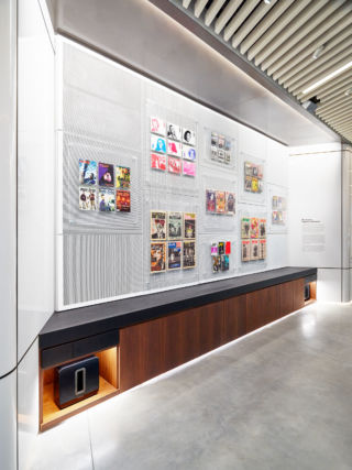 Vintage music magazine covers adorn one wall in a museum-style display.
