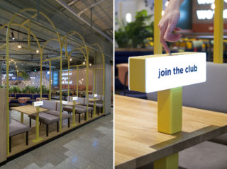 Switch on your light to suggest that you are happy to welcome someone else sit at your table and are free to chat - Crowd Club Cafe at Eindhoven Airport