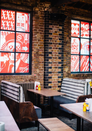 Carriage seating from bygone days provides a nod to the Kings Cross location of MEATliquor's restaurant, along with graphics that provide the brand's distinctive tone of voice