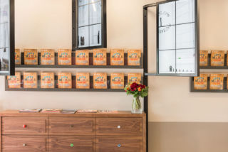 Domestic furniture provides a homely backdrop with digital 'Crittall windows' providing a fresh approach to the display of digital screens in their concept for estate agents Strutt & Parker