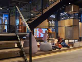 Interactive screens and plush seating provide a space for kids to hang out.
