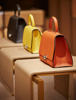 In Moynat's Mount St. store in London, handbags are placed on draped leather tables, which reflect the structured design of the product