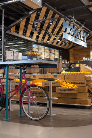 Wooden crates, fresh fruit and quirky bicycles reference Amsterdam’s local market scene.