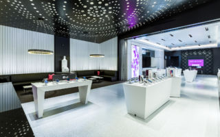 The store highlights T-Mobile's iconic magenta brand identity and its diverse mobile device and service offerings with all the glamour appropriate for the store's Las Vegas Strip location 