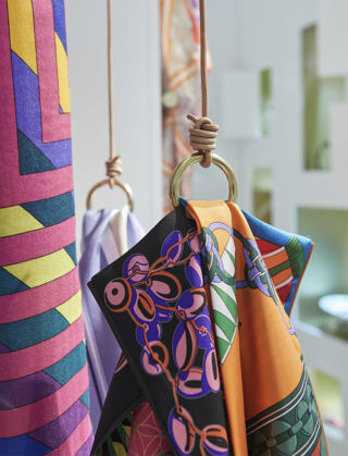 Hermès’ iconic silk scarves hang from bespoke hangers.