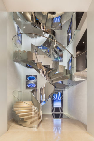 A ribbon-like staircase forms a central statement.