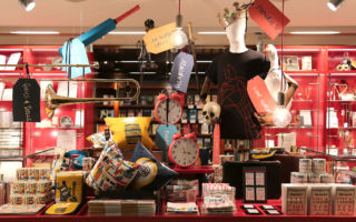 We love the way simple tagging and hanging of products adds life to the merchandise - National Theatre store, London