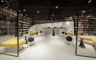 The book-lined reception area of the Wheat Youth Arts Hotel in Hangzhou, which is located on the 7th floor of a shopping centre. The angular forms seen here are also reflected in the design of each bedroom interior