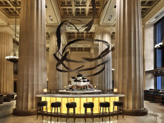 Retaining the building's historic monolithic interior, the bar features beautiful backlit onyx and a 350ft swirling sculpture, creating a 'glowing altar' within the centre of the space, creating a sense of occasion in Nobu's Downtown NY restaurant