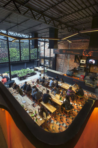 An open-plan footprint and communal seating facilitate community connections.