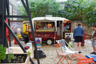 An outdoor patio features food carts and events.