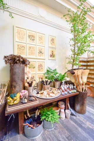 Garden-inspired products and artisanal yard tools rustically gather in the shop.