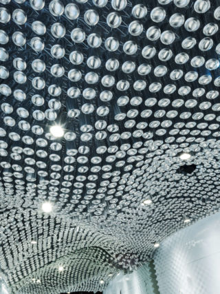 The overhead canopy has been fashioned from recycled cans.