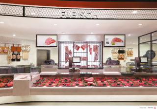 Visual merchandising includes backlit product displays and complementary kitchenware.