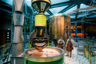 In a Starbucks world-first, customers can walk right around the bright-green Scolari roaster.