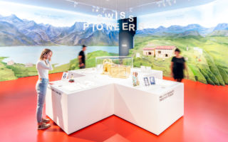 A playful display of doll's house like displays overlaid with film helps tell the story of Switzerland's chocolate-making pioneers. 
